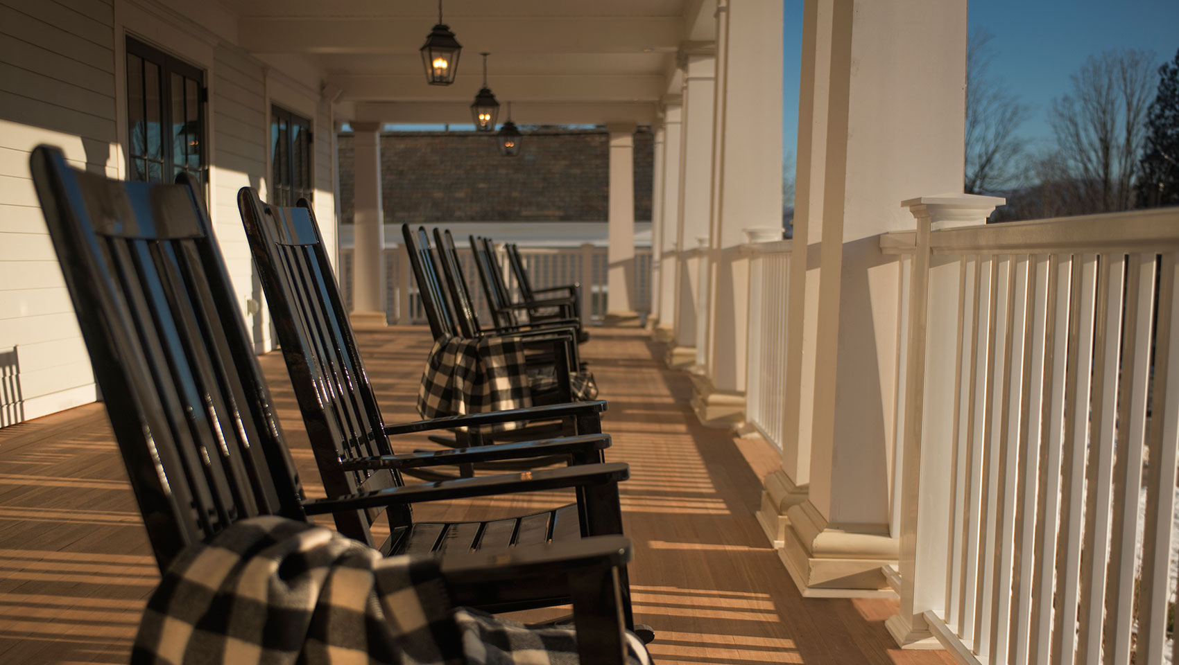 black rocking chairs on the front porch of the hotel