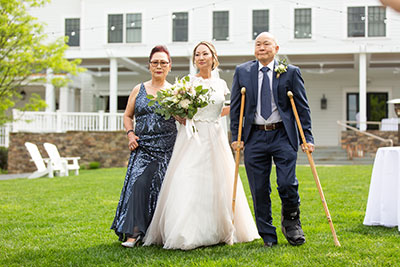 Bride walking down the aisle with parents