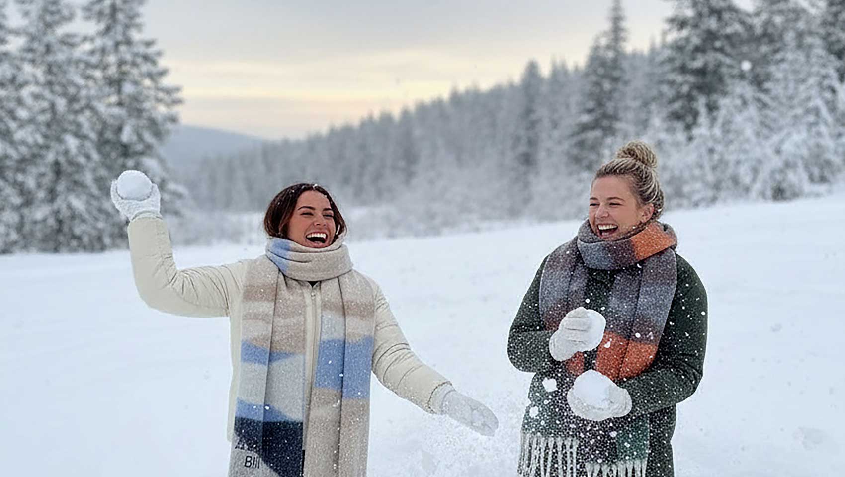 two women throwing snowballs