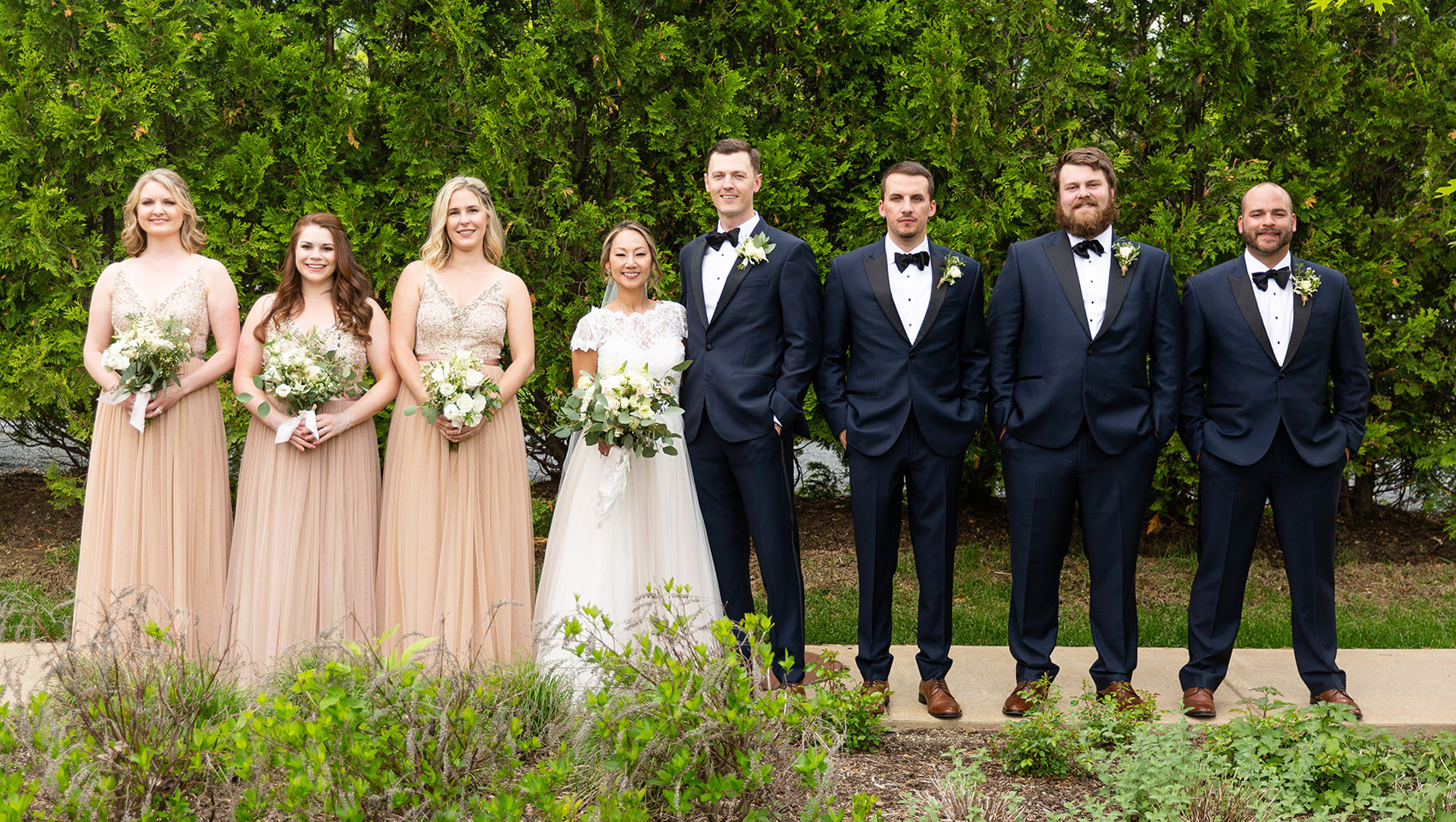 Bridal party and Groomsmen posing with bride and groom