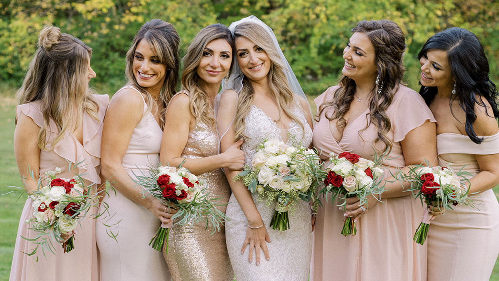 Bridal party posing with flowers