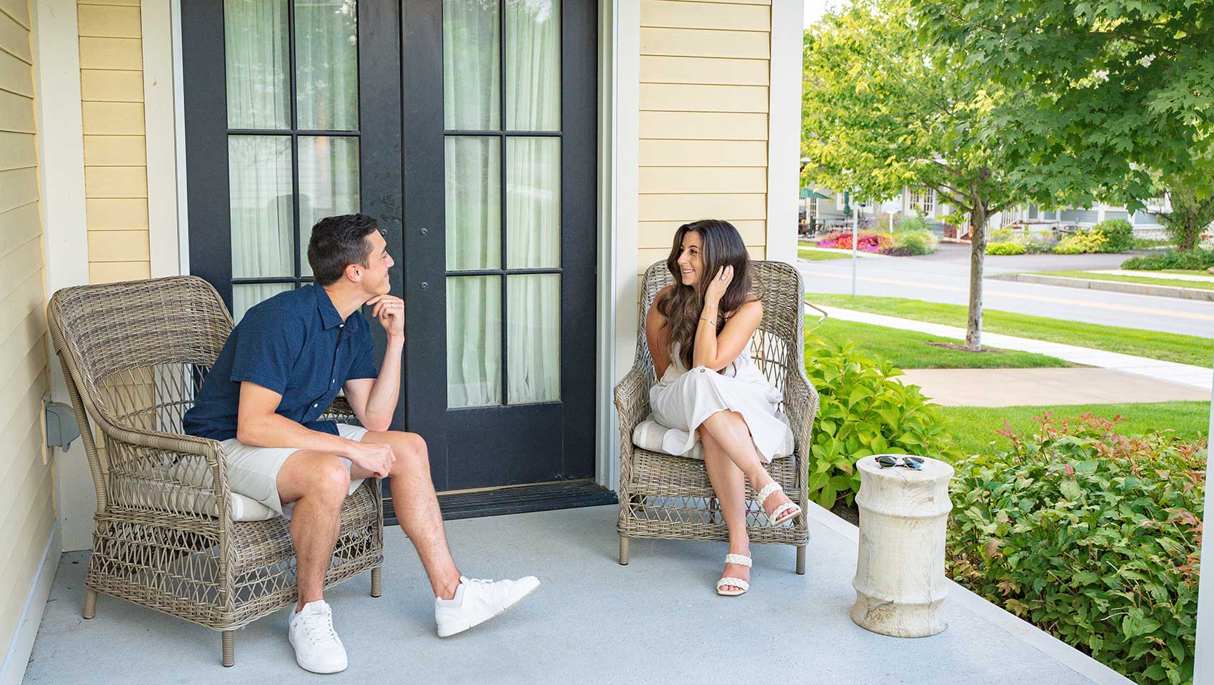 Couple sitting outside  looking at each other at Kimpton Taconic