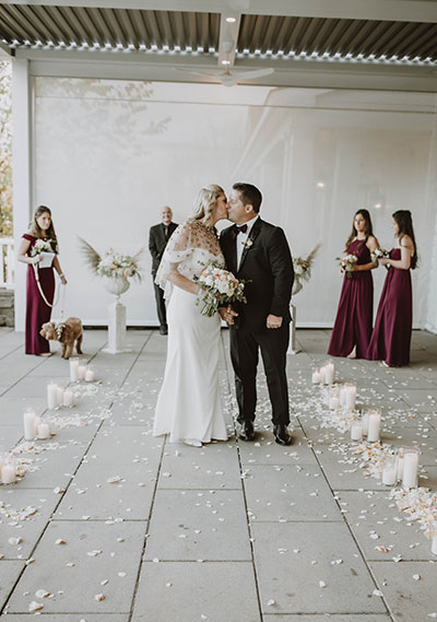 Bride and Groom kissing in aisle
